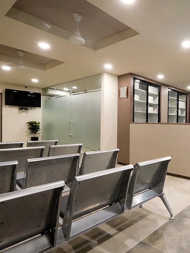 The waiting area at Vishwas Orthopaedic Hospital, Bharuch, with steel seating outside the consulting cabin