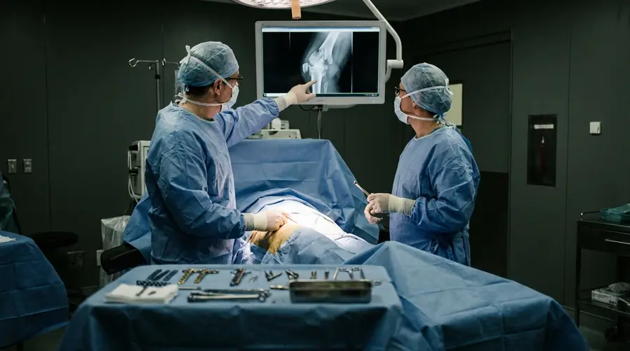 Surgeons studying the X-ray of an un-united fracture before corrective reconstruction surgery