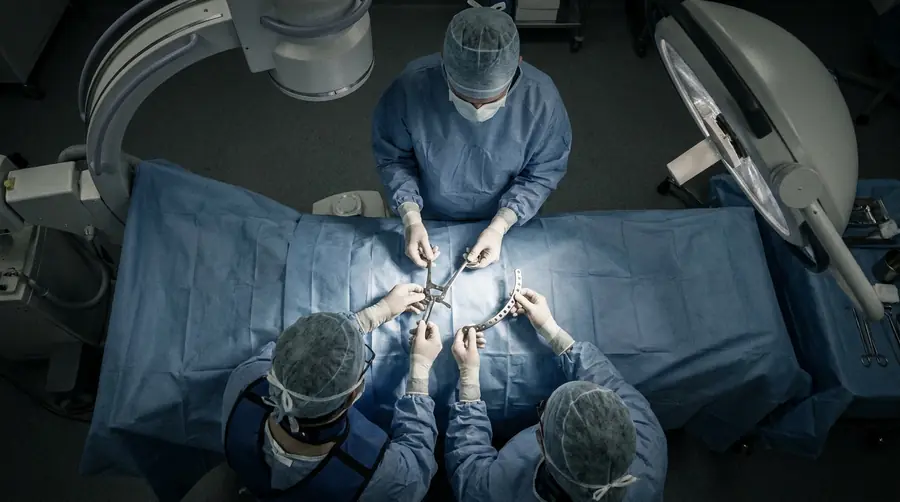 Surgeons using a reduction clamp and reconstruction plate during pelvic and acetabular fracture fixation